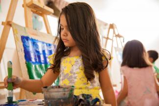 girl painting in art class