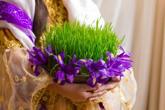 girl holding wheat grass and irises